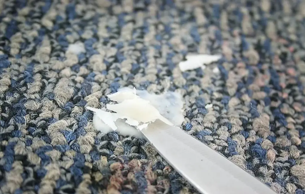 a butter knife, remove wax stain